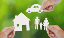 Hand holding a paper home, car, family, insurance concept